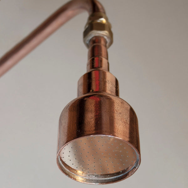 Copper shower head made by hand in unlacquered copper and brass by Switchrange