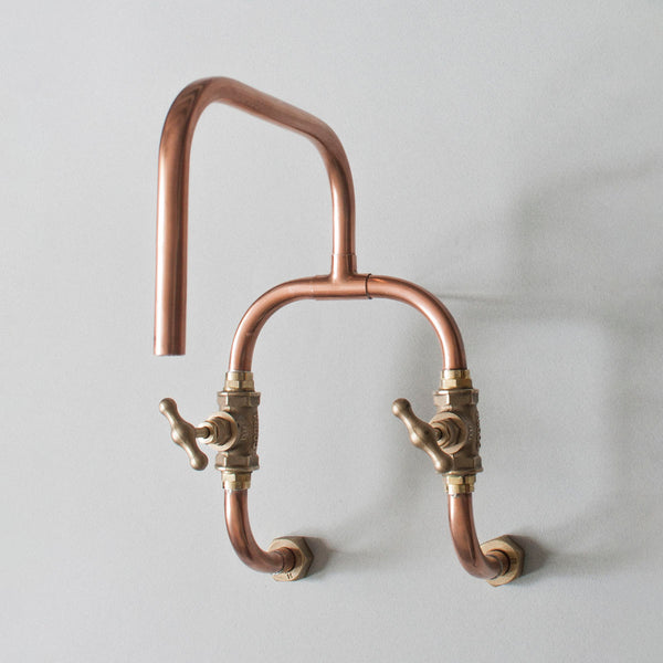 Loop is a handmade copper wall mounted kitchen or bathroom tap for indoor or outdoor use made from pure copper and brass by Switchrange.